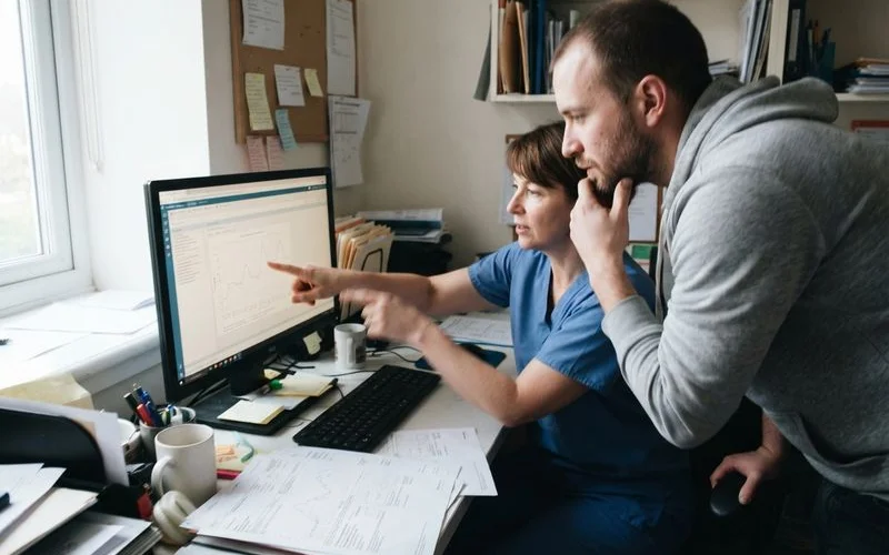 A man reviewing lab results with a healthcare provider during a morning consultation appointment